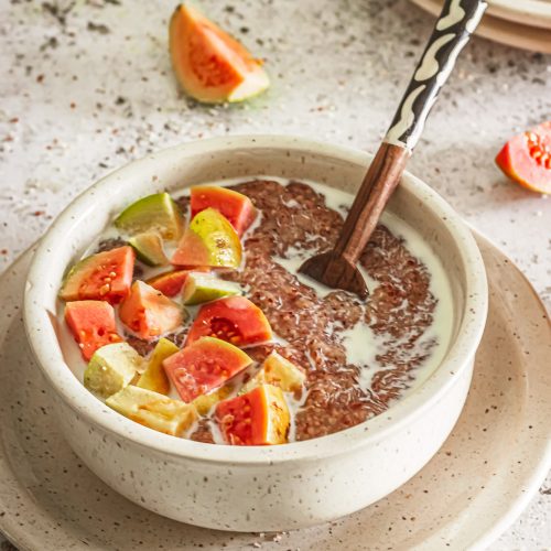 A wholesome South African breakfast of sorghum porridge, served with ripe guavas and milk. Nutty, creamy, and naturally gluten-free.