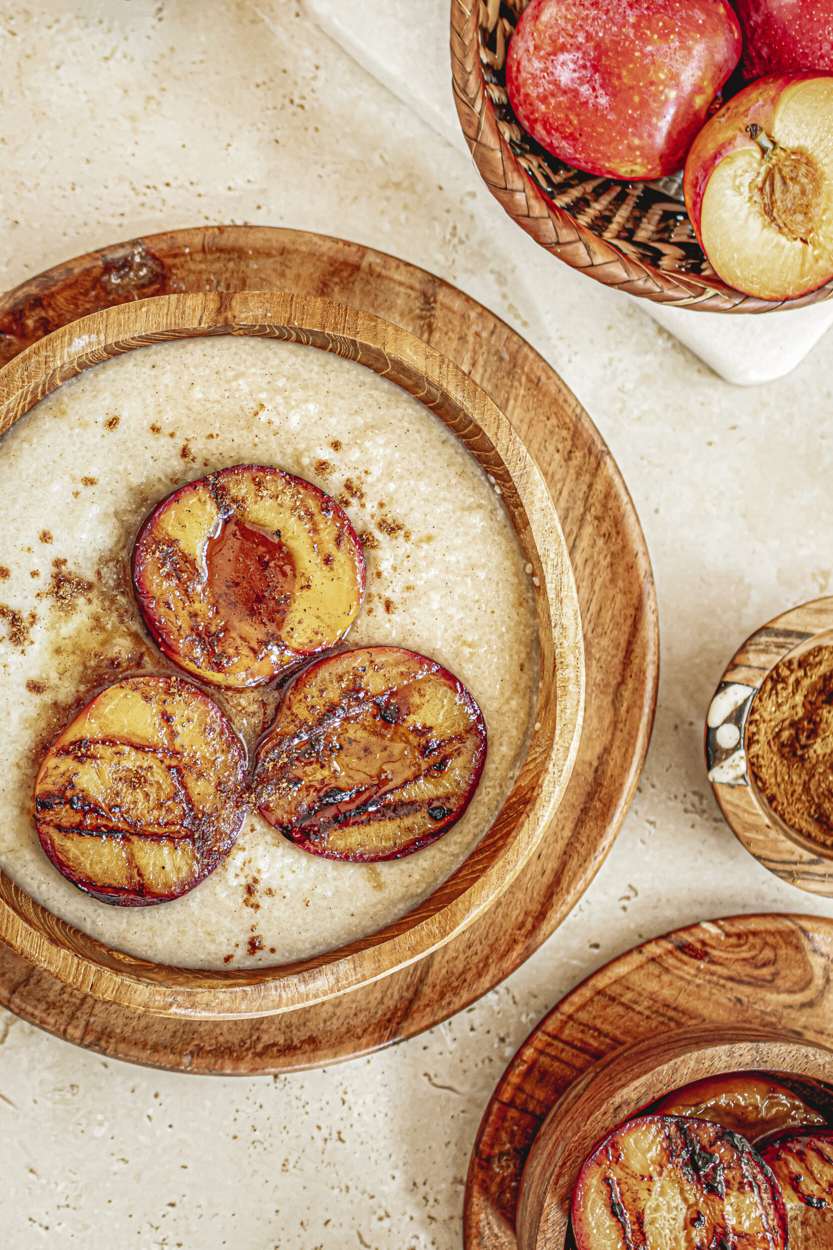 Fonio porridge served with grilled plums and drizzled with maple syrup. 